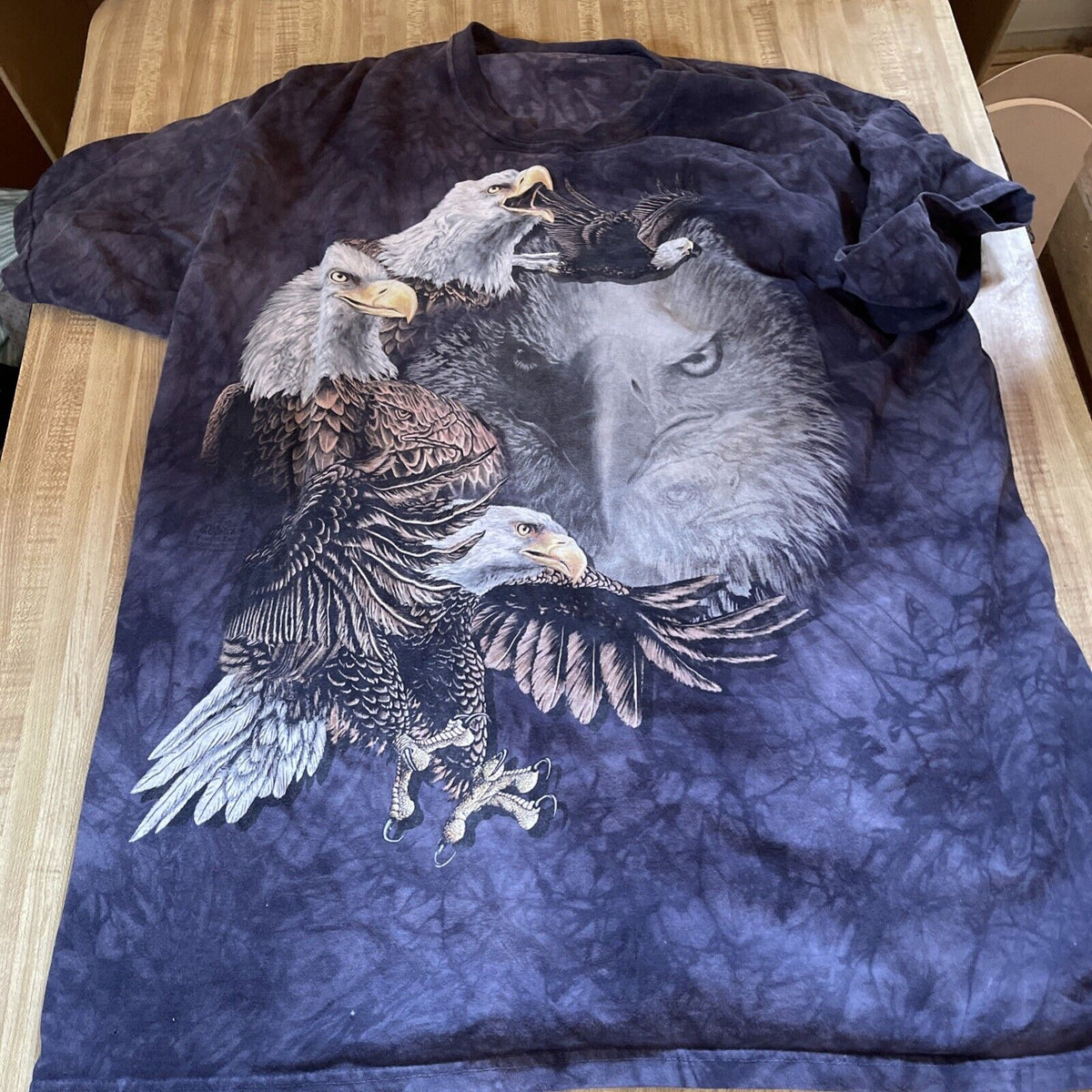 The Mountain eagle shirt with detailed eagle and wolf graphic on a dark blue tie-dye background