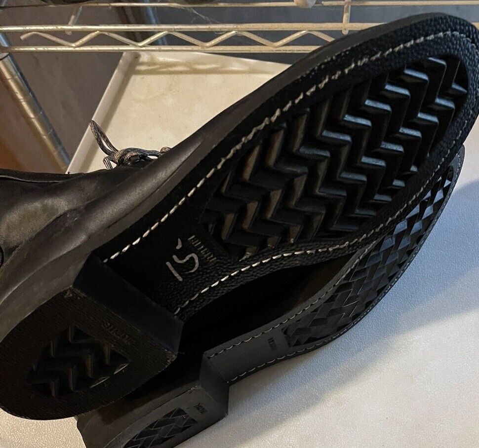 Sole view of vintage Addison combat boots showing durable black tread and stitching details