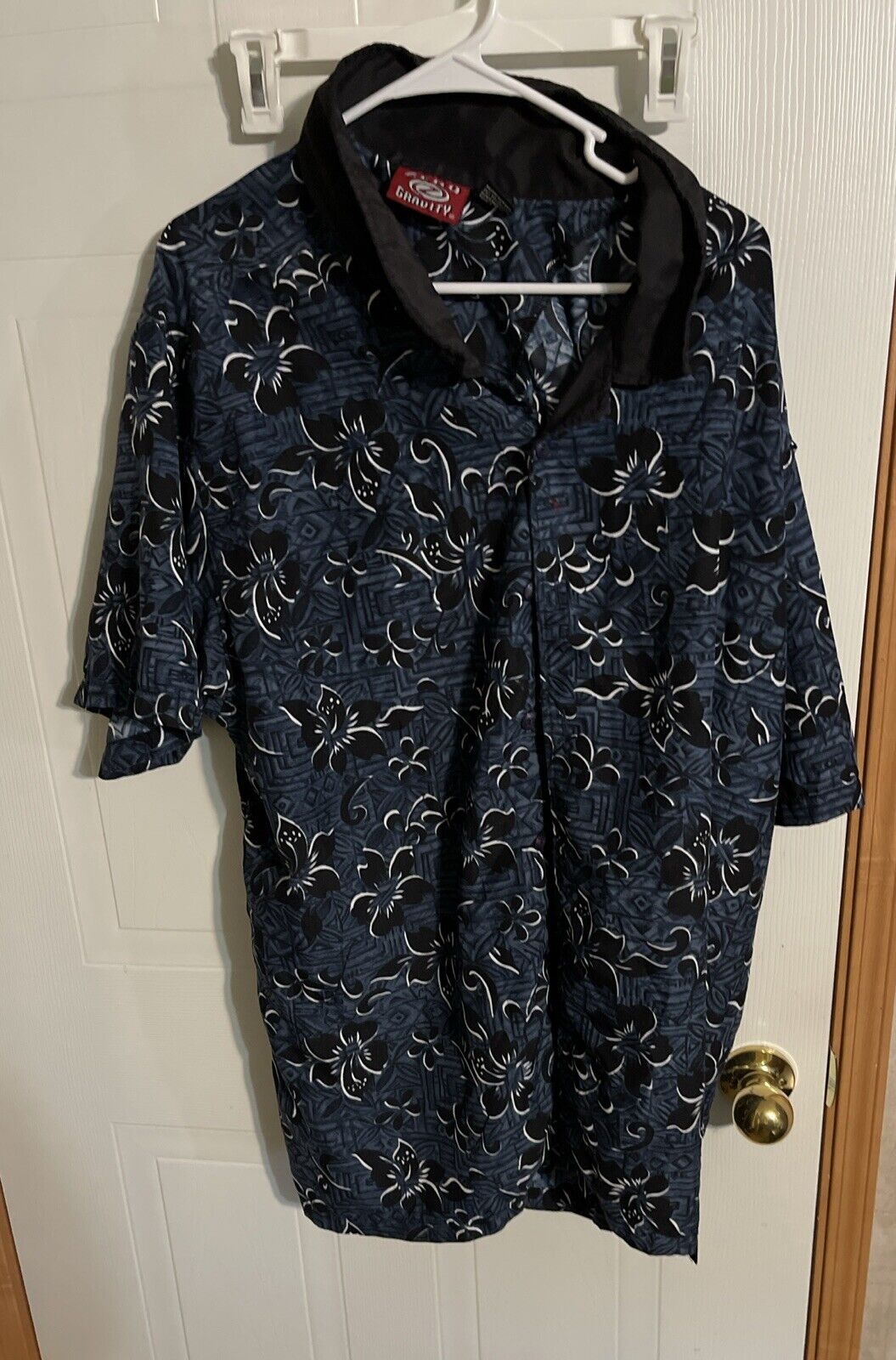 Zero Gravity Hawaiian shirt XL with black and white floral print hanging on white hanger