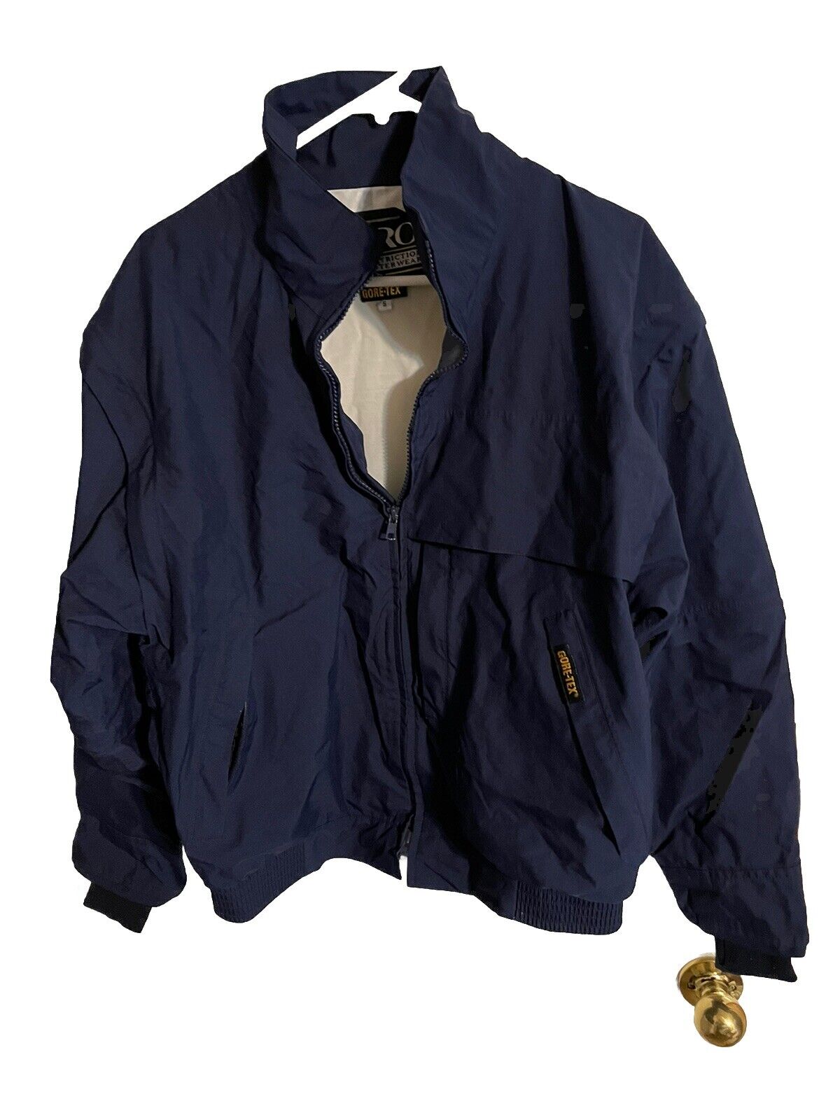 Navy blue zero restriction Gore Tex golf jacket with front zipper and high collar by 1118 Emporium